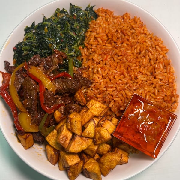 A Jungle Plate African-fusion dish with jollof rice, stewed greens, beef, plantains, and sauce.